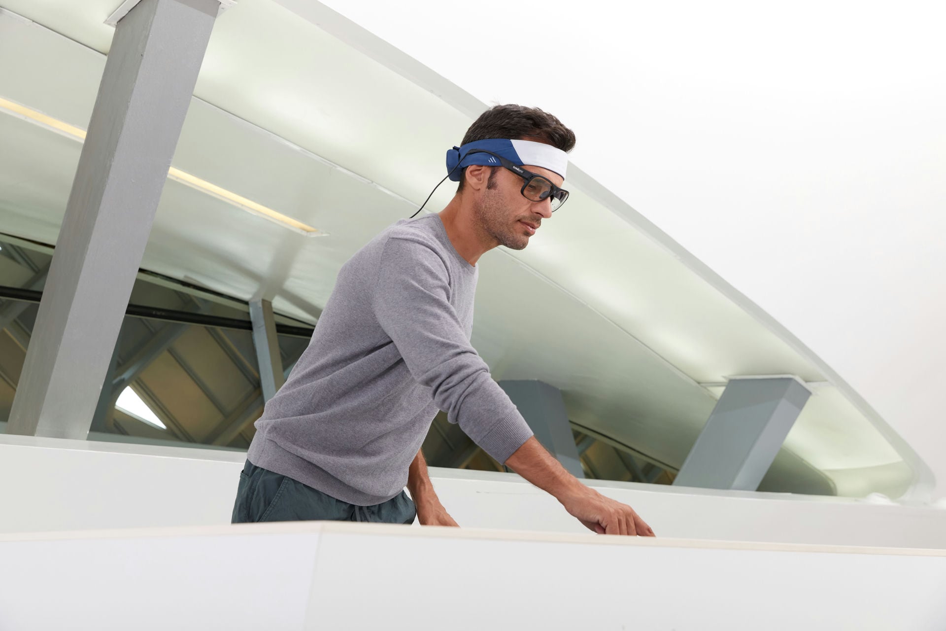 Man wearing Bitbrain's Ikon headband while performing a task Man wearing Bitbrain's Ikon headband while performing a task