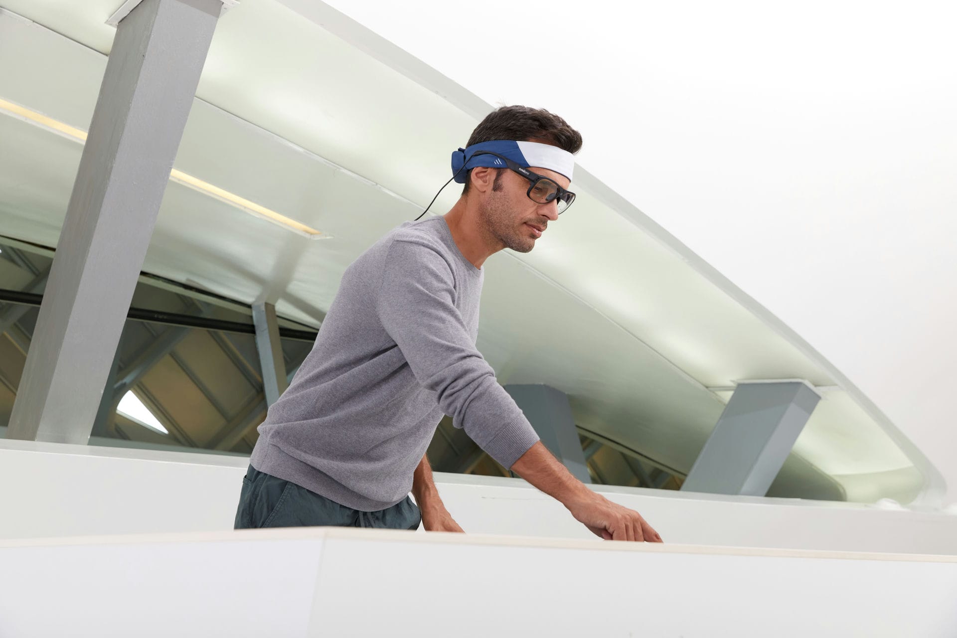 Man wearing Bitbrain's Ikon headband while performing a task Man wearing Bitbrain's Ikon headband while performing a task
